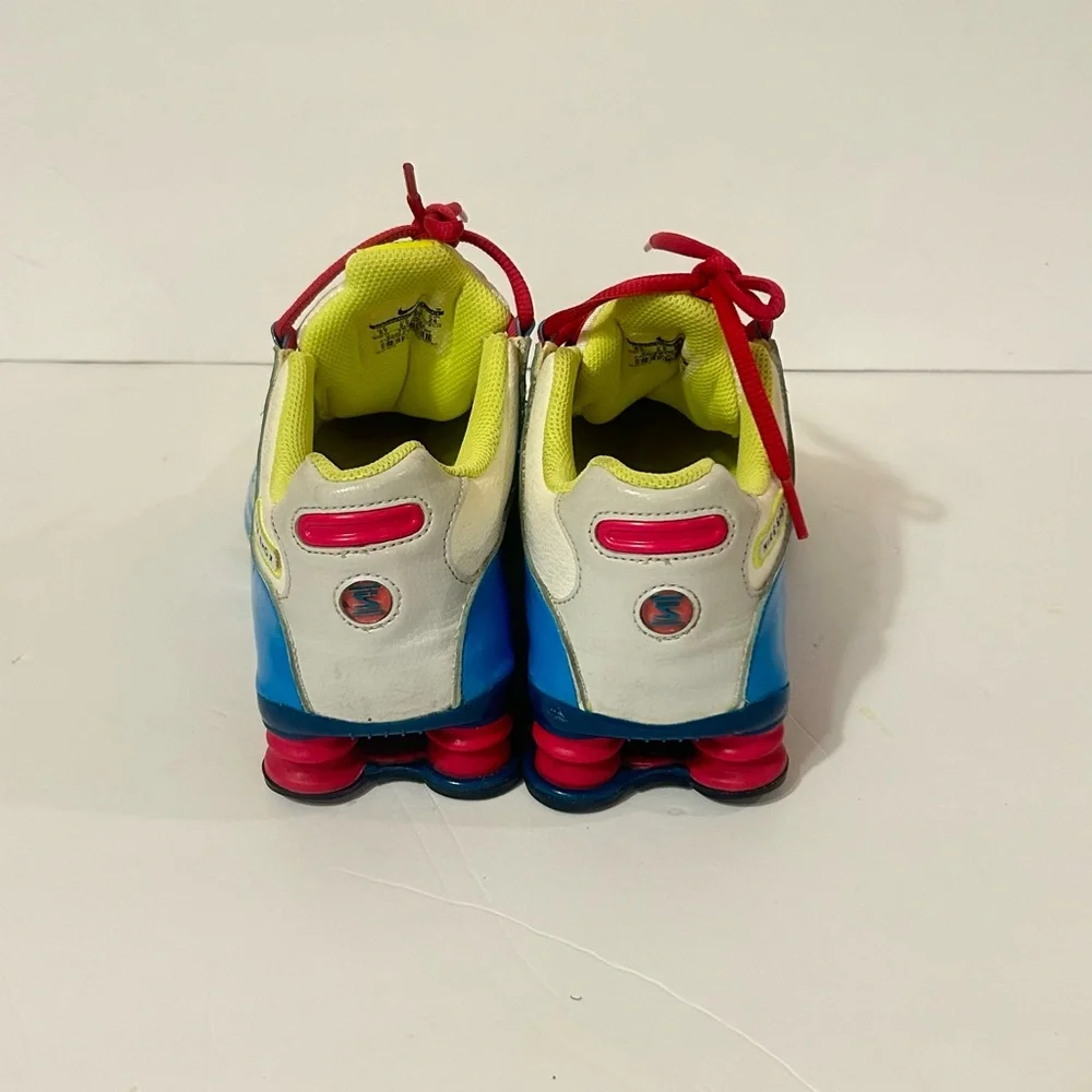Nike Kids Shox Sneakers in White with Blue, Pink & Neon Yellow Accents